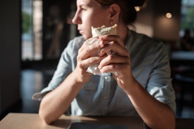Man eating a fast food burrito