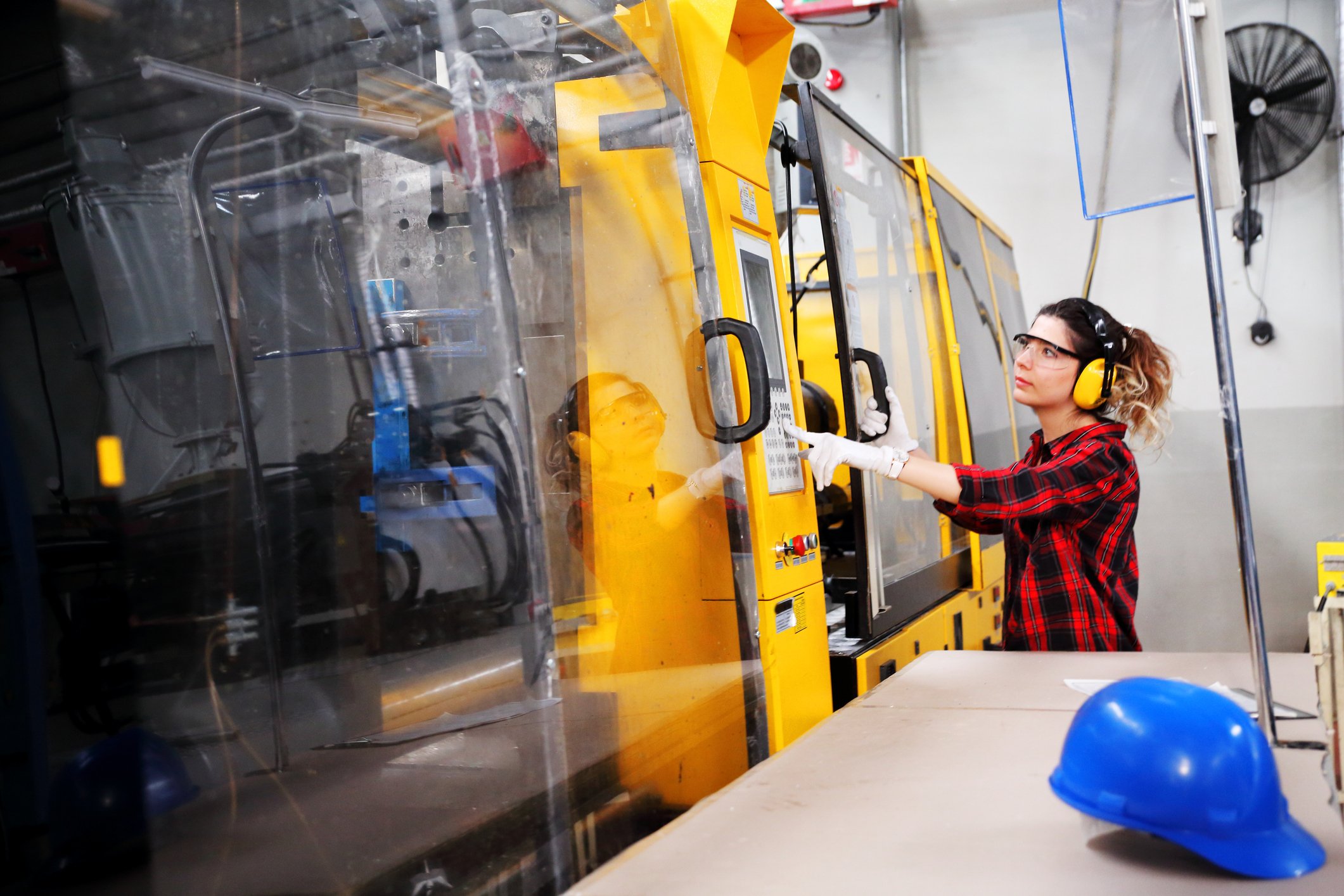 Photograph of woman working in a manufacturing facility.