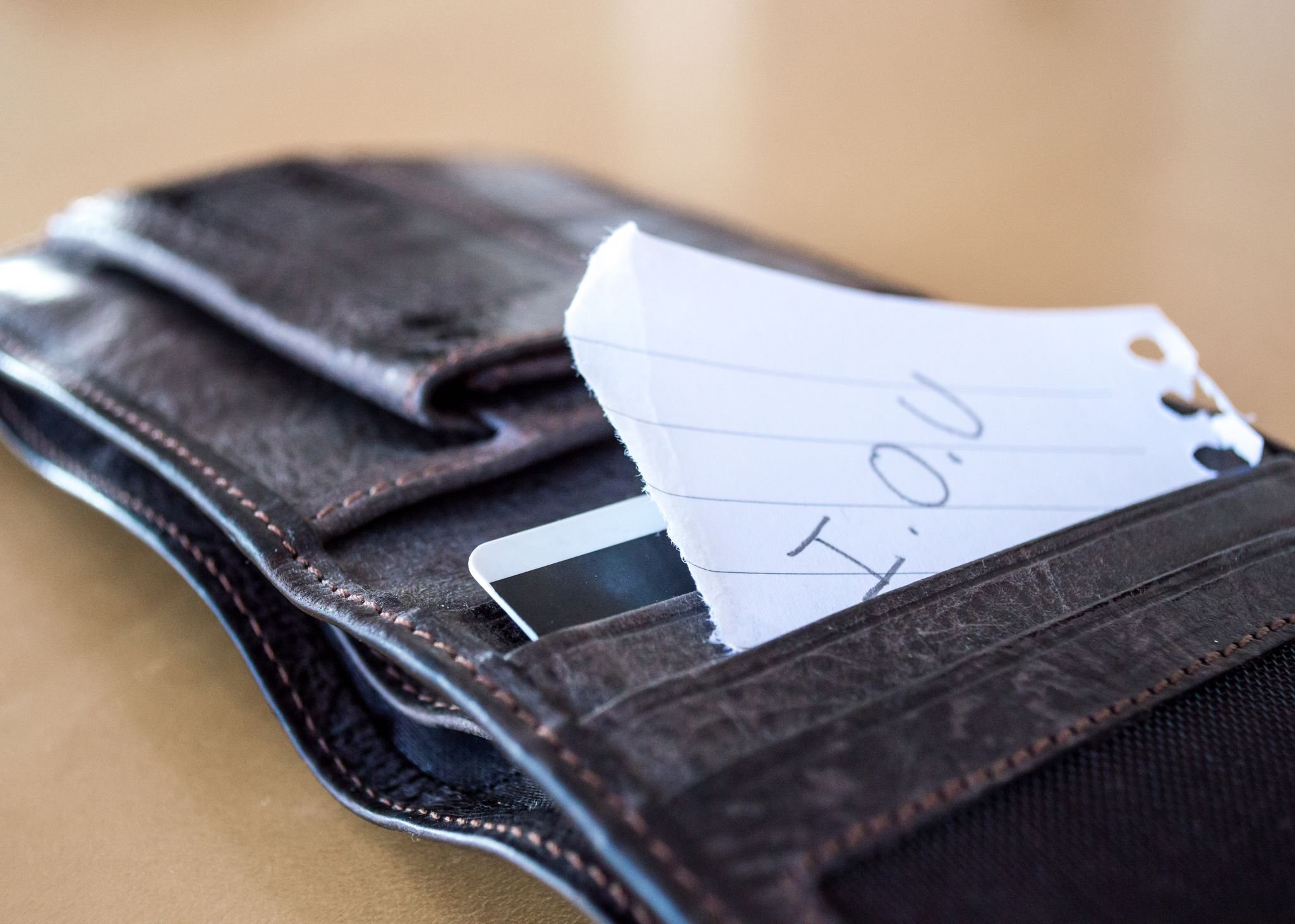 Empty wallet with IOU slip in it