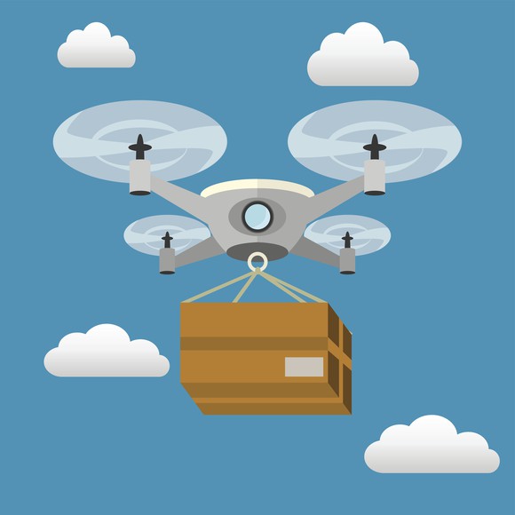 Quadcopter delivery drone carrying a package