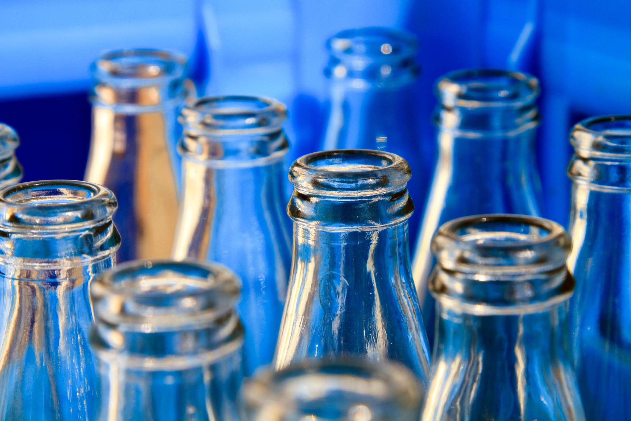 Close-up of empty soda bottles in a bottling plant.