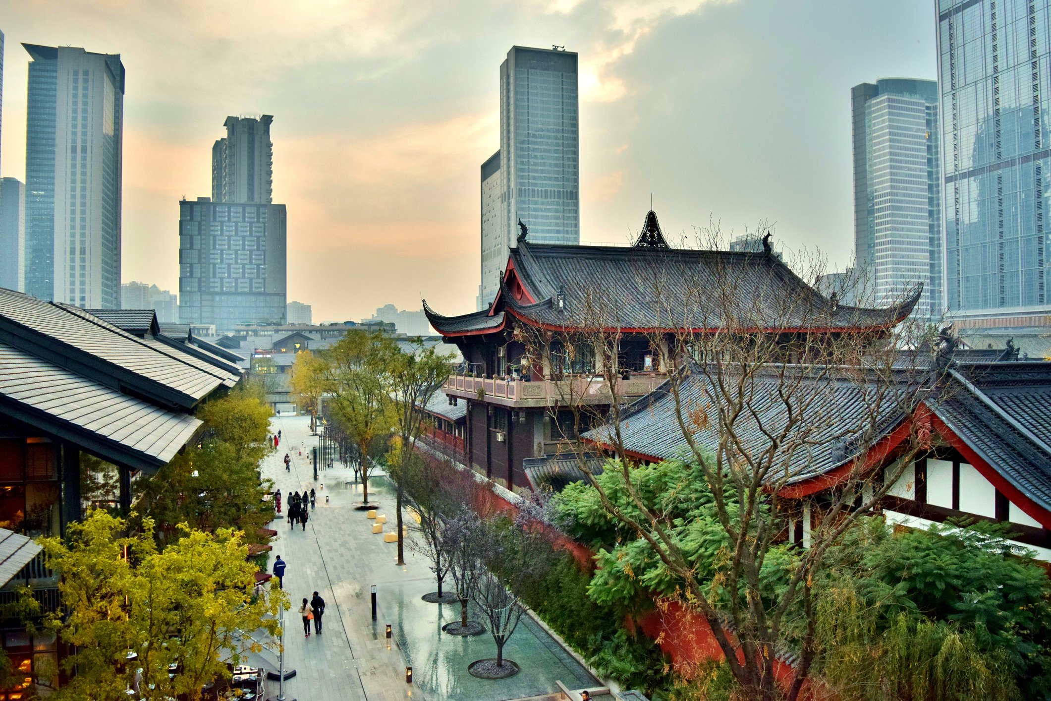 Traditional Chinese temples are pictured against a modern Chinese financial district.