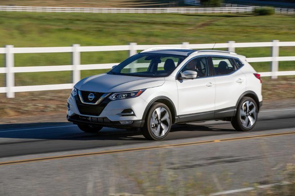 The 2020 Nissan Rogue, driving on a country road.
