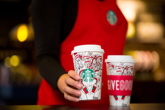 Barista setting out two holiday Starbucks cups