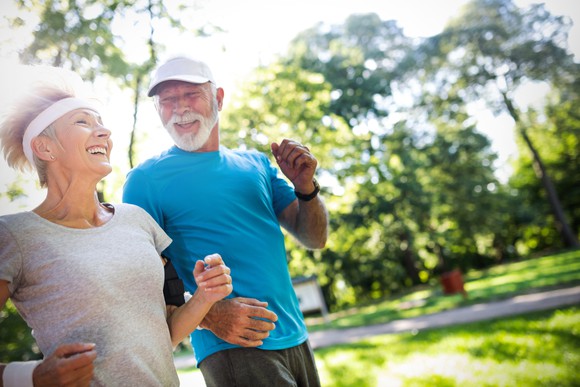 Older couple running outside