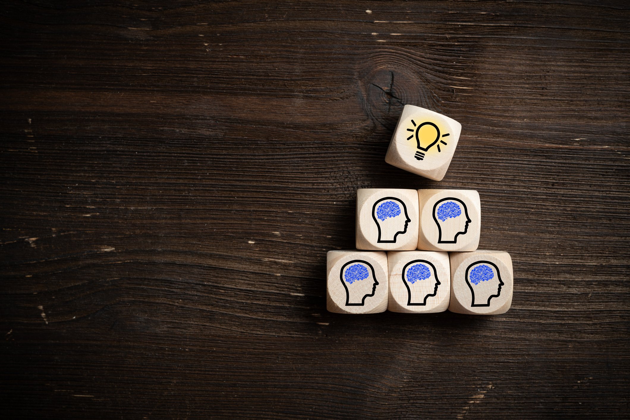 Wooden dice with icons on them to represent inspired ideas