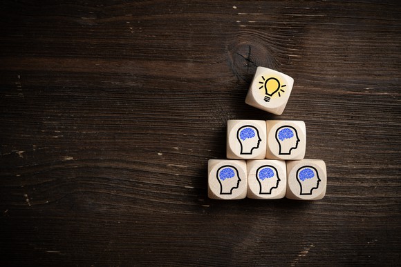 Wooden dice with icons on them to represent inspired ideas