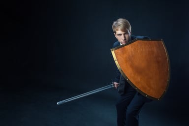 Businessman with shield and sword