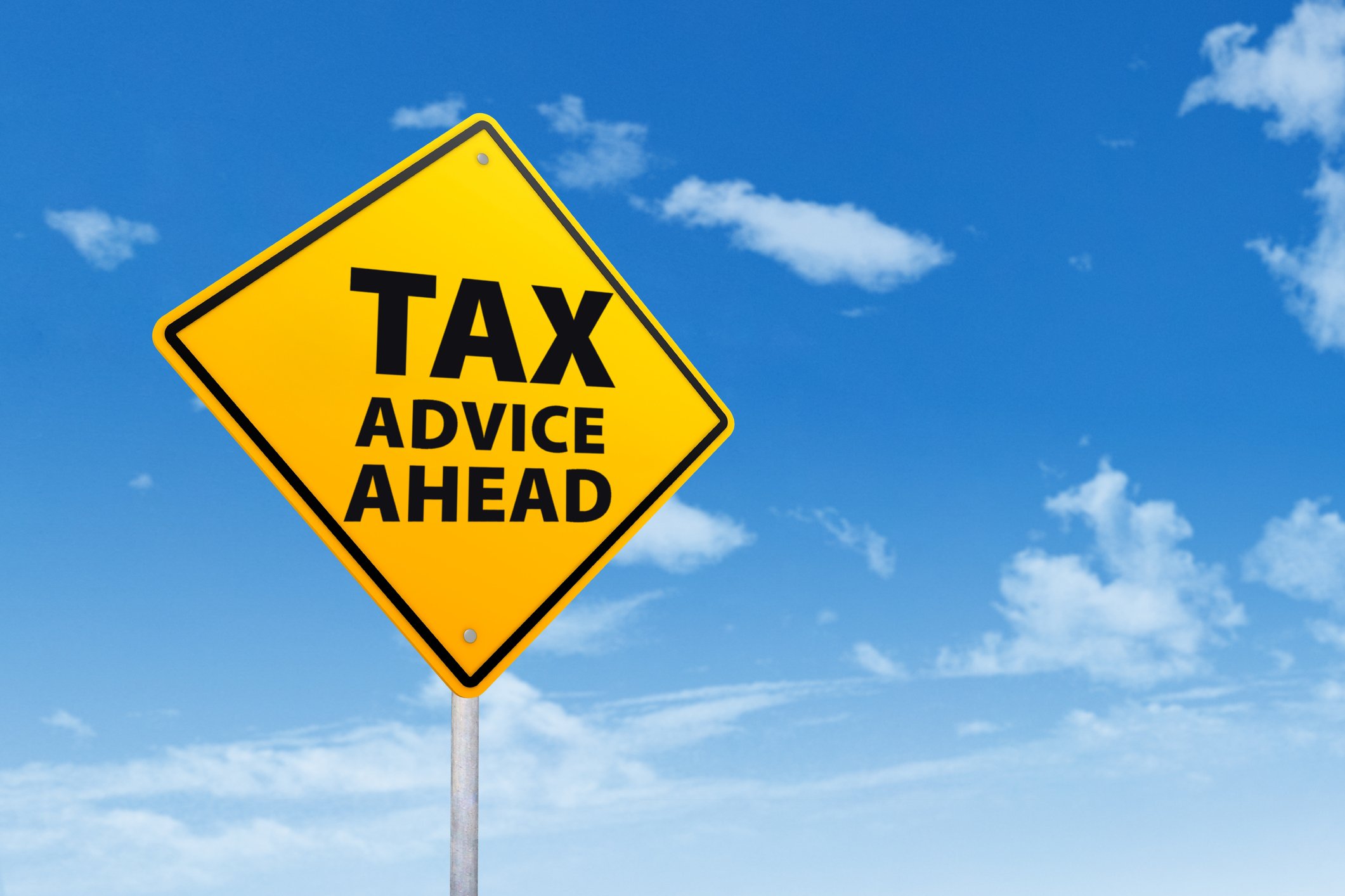 A yellow road sign says tax advice ahead. 