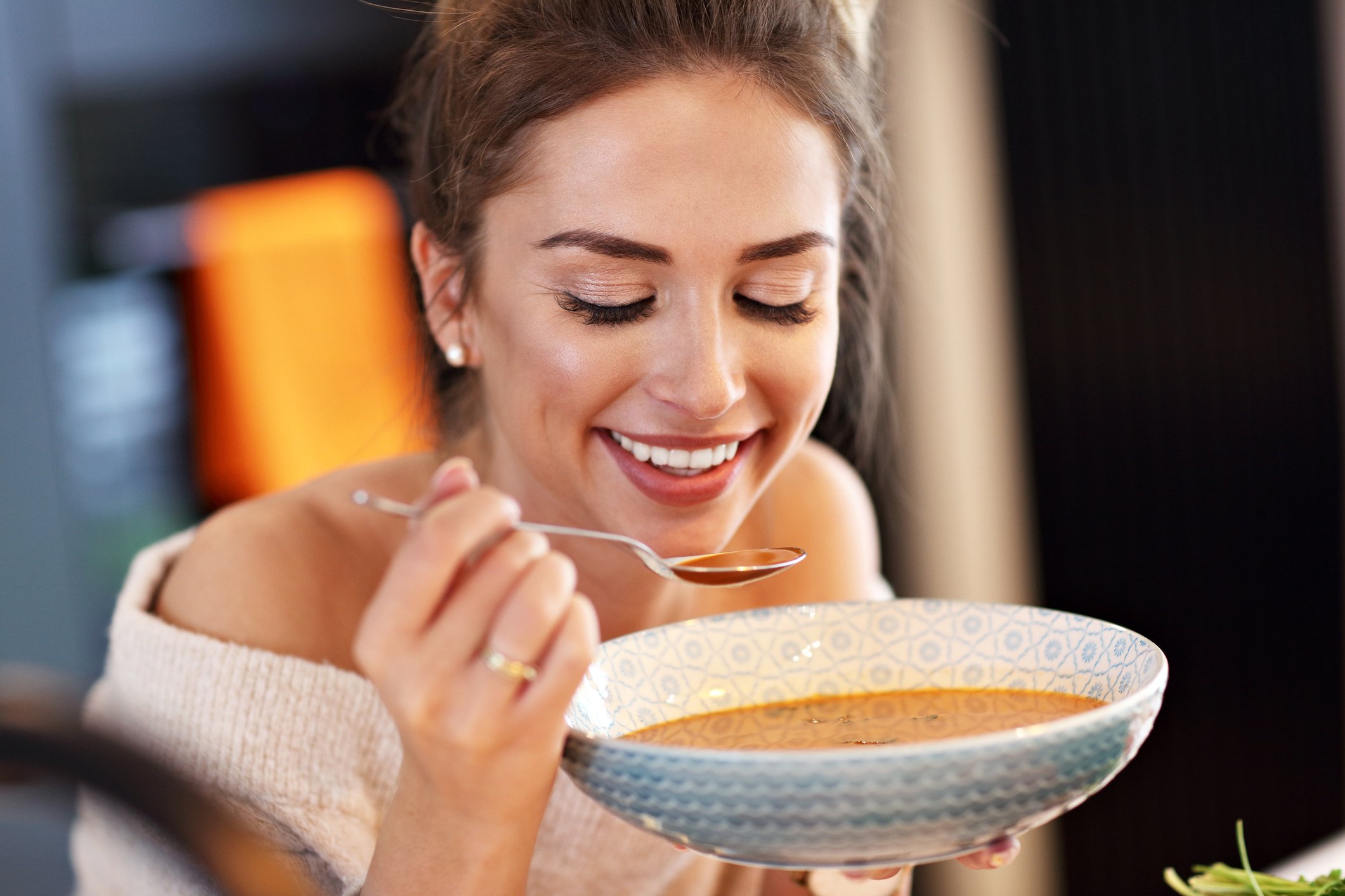 Woman eating soup.