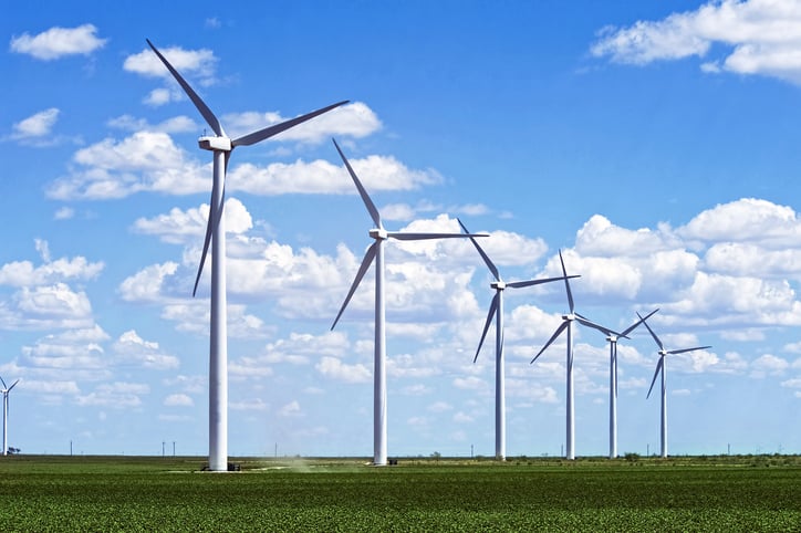 A row of wind turbines in a field