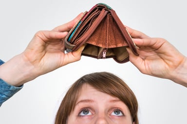 woman holding empty wallet