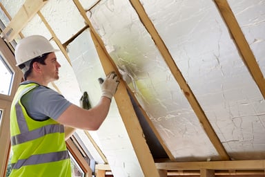 Builder Fitting Insulation into Roof
