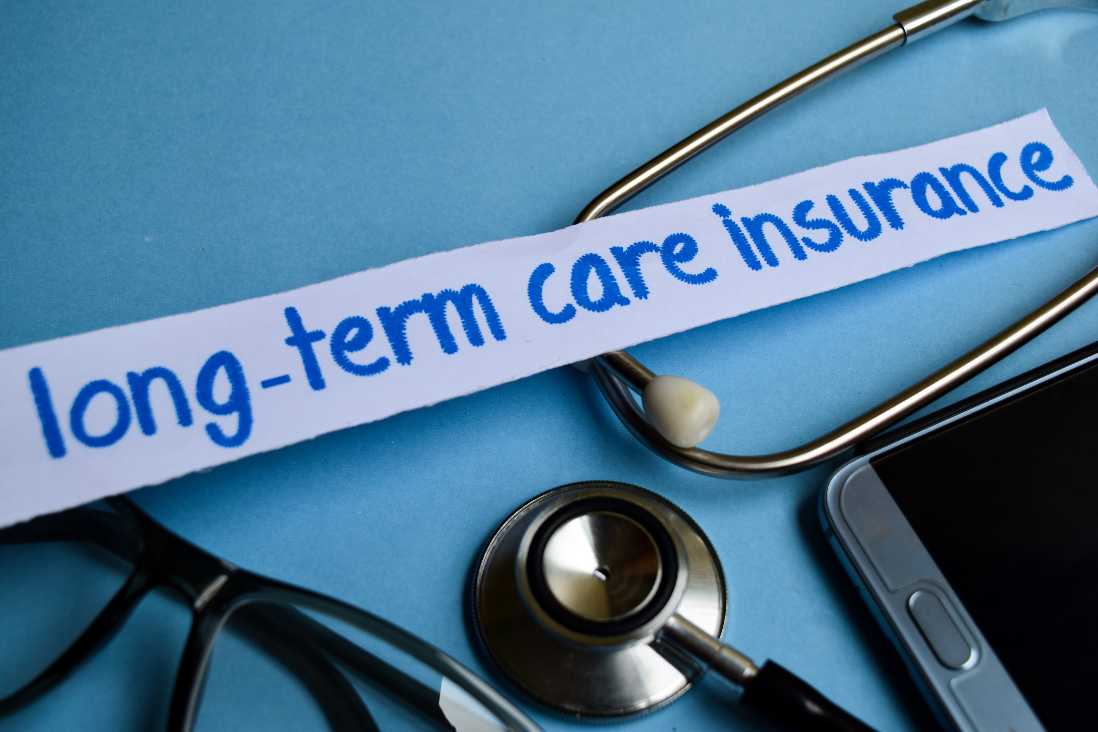 Stethoscope, glasses, and phone with words "long-term care insurance"