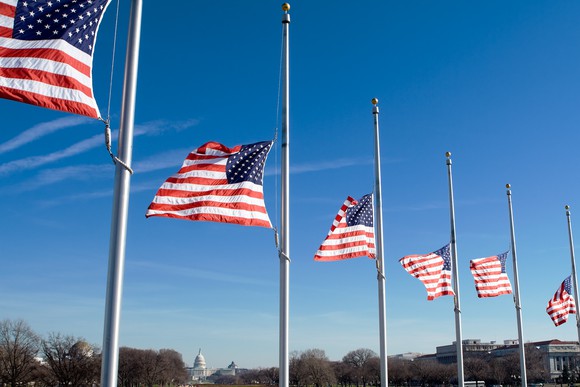 Six American flags at half mast