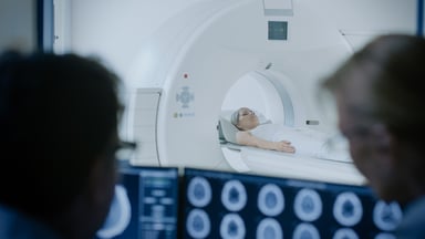 MRI scanner and young woman