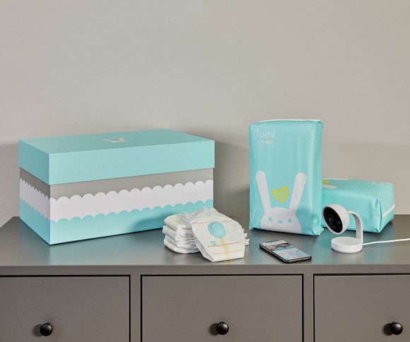 The Lumi by Pampers system with monitor, diapers, etc. arranged on a dresser