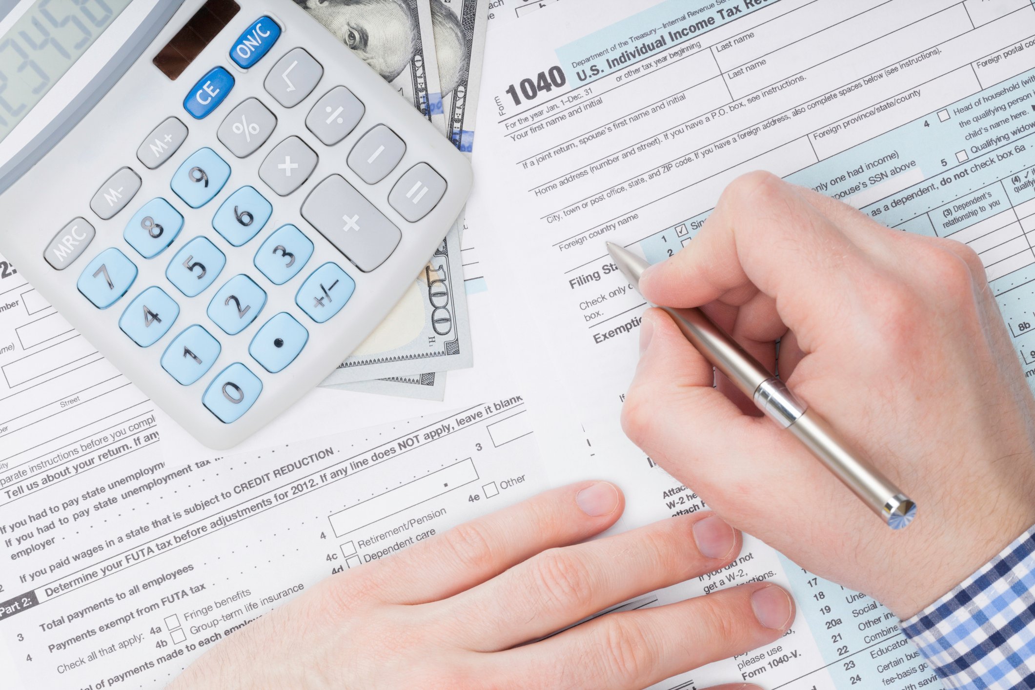 Person filling out tax forms.