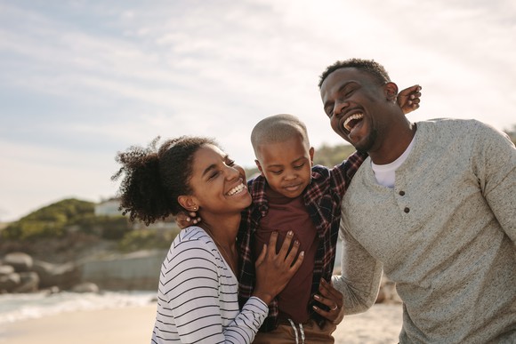 Young family having fun at the beach