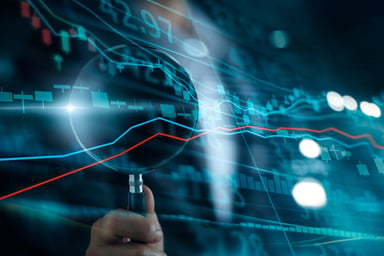 Magnifying glass with stock charts