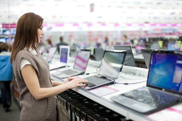 Photograph of woman shopping for a new laptop.