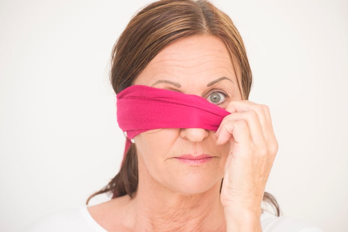 Mature woman removing blindfold
