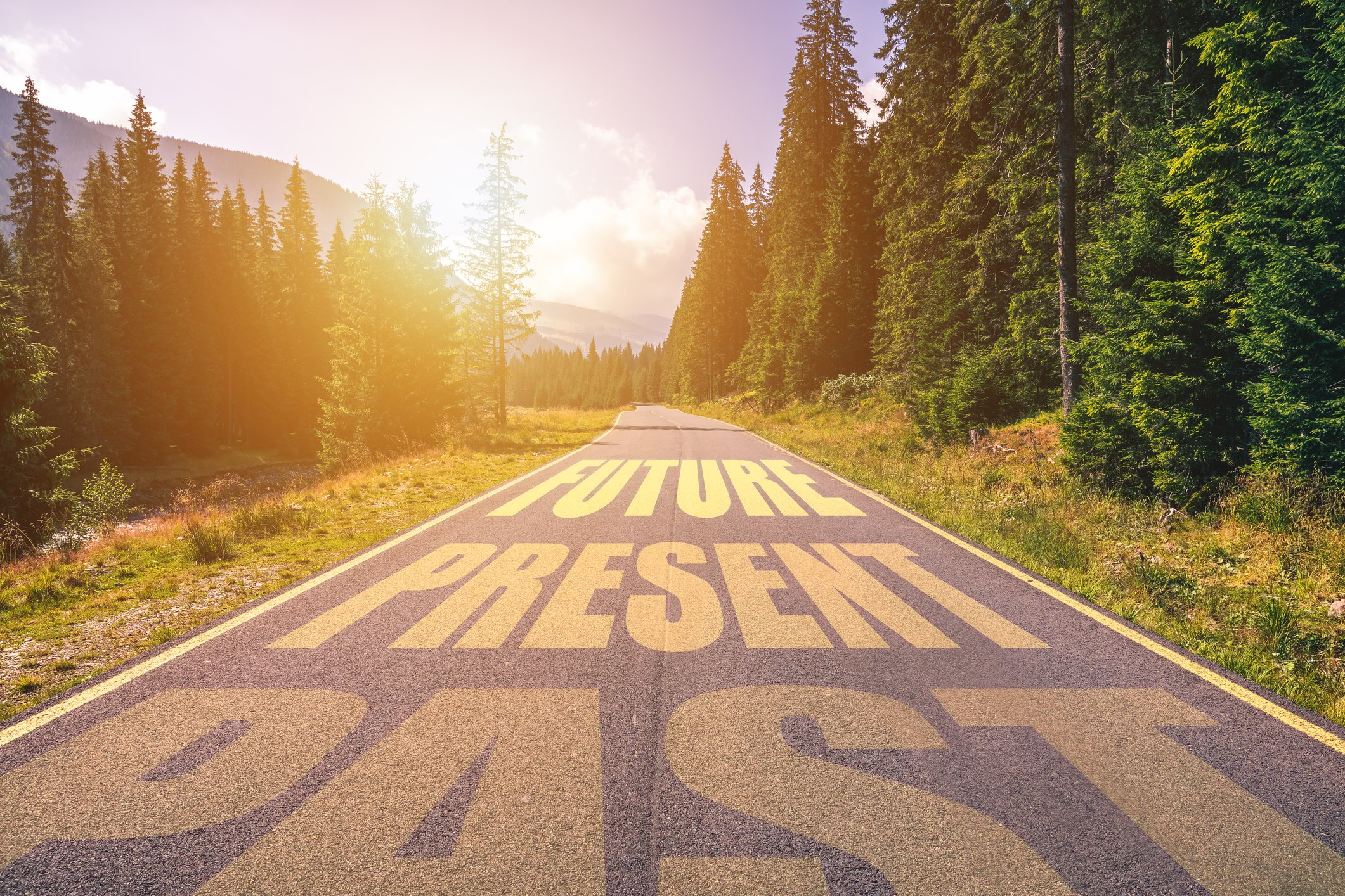 A Road extends into the future with the words Past, Present, and Future.