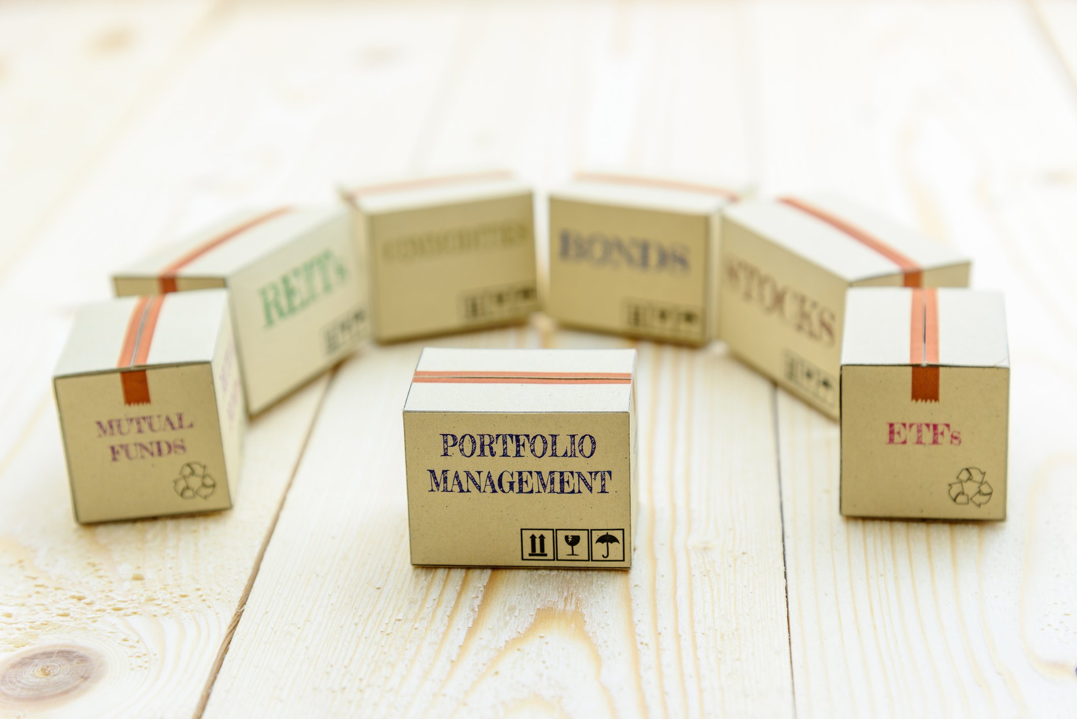 Set of blocks reading "mutual funds," "ETFs," "bonds," "stocks," "REITs," and "portfolio management"