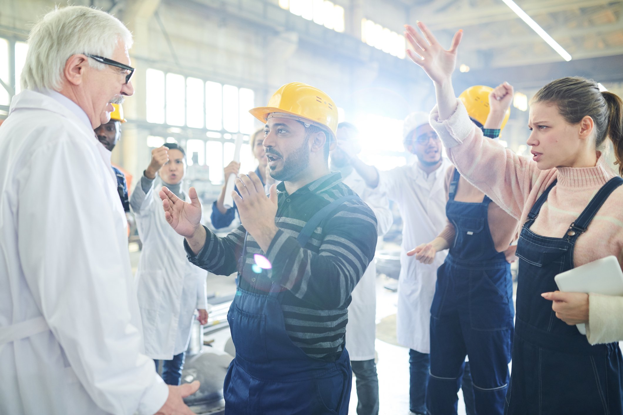 Workers in a plant having a heated discussion in a facility.