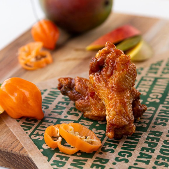 chicken wings next to sliced habanero