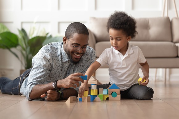 Father and child playing with blocks