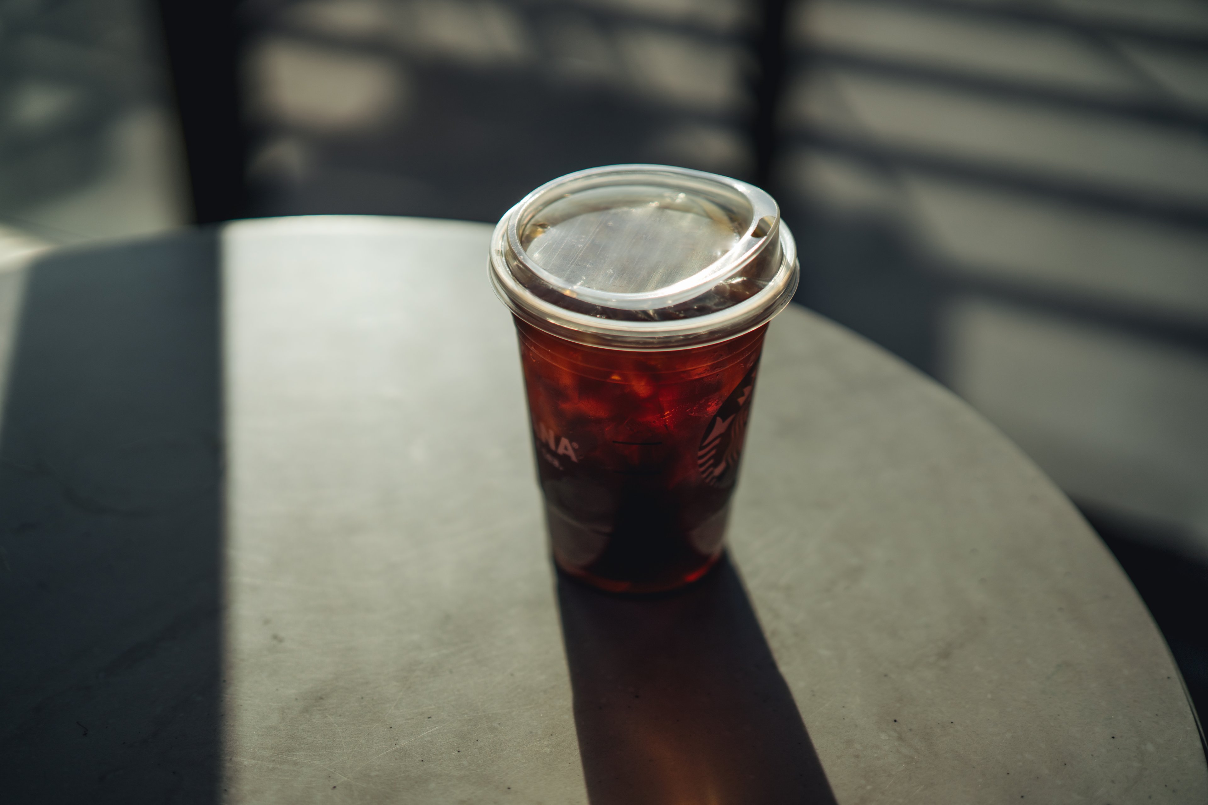 A plastic Starbucks cup with a lid resembling a toddler's sippy cup