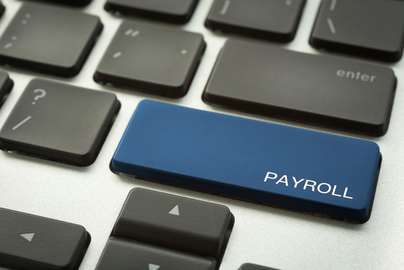 Photograph of computer keyboard with a "payroll" key