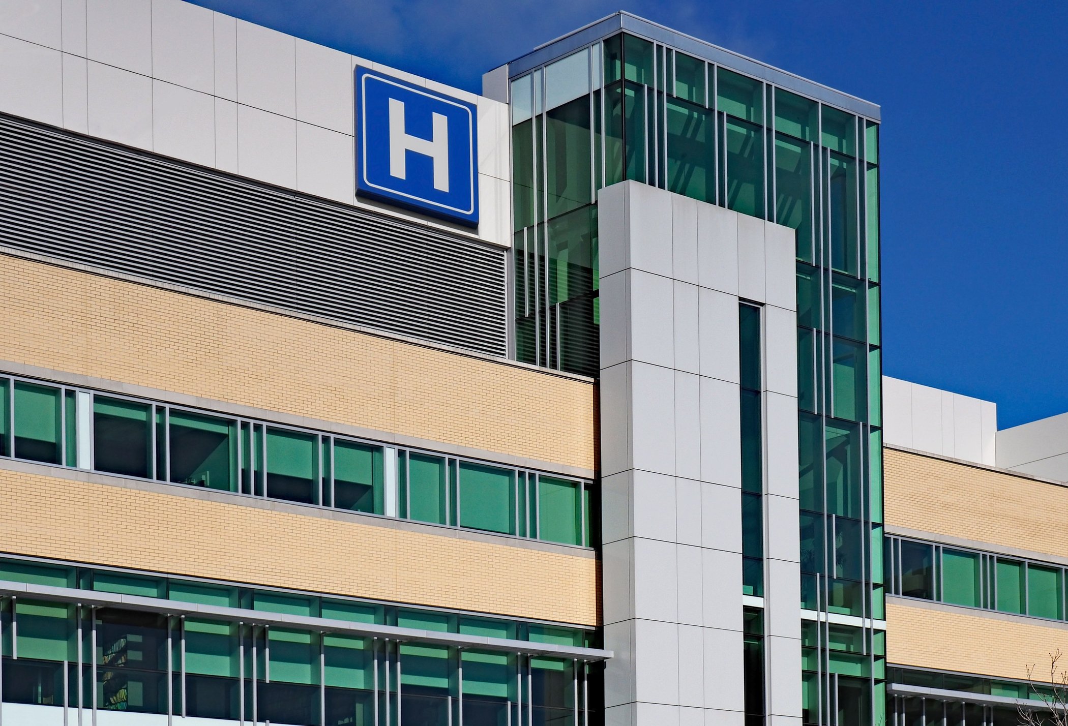 Hospital building with 'H' sign displayed.