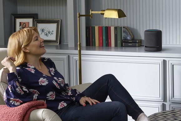 Woman listening to an Echo Studio.