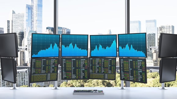 A fancy office with 12 monitors and a great view of a big city
