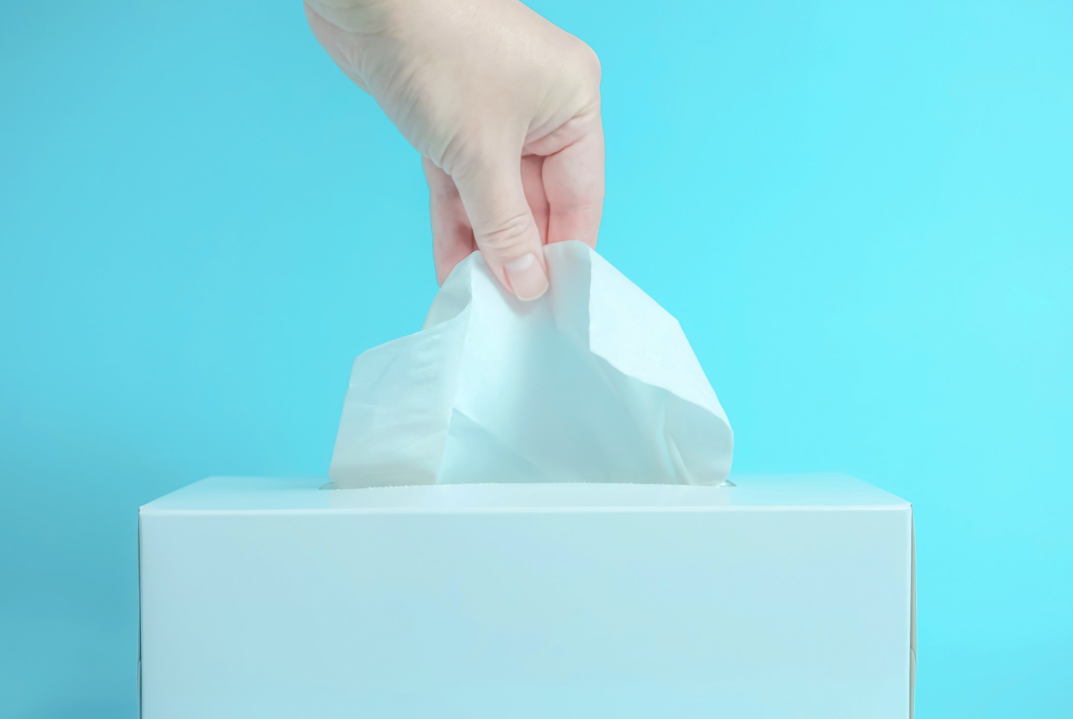 A tissue being pulled from a box.