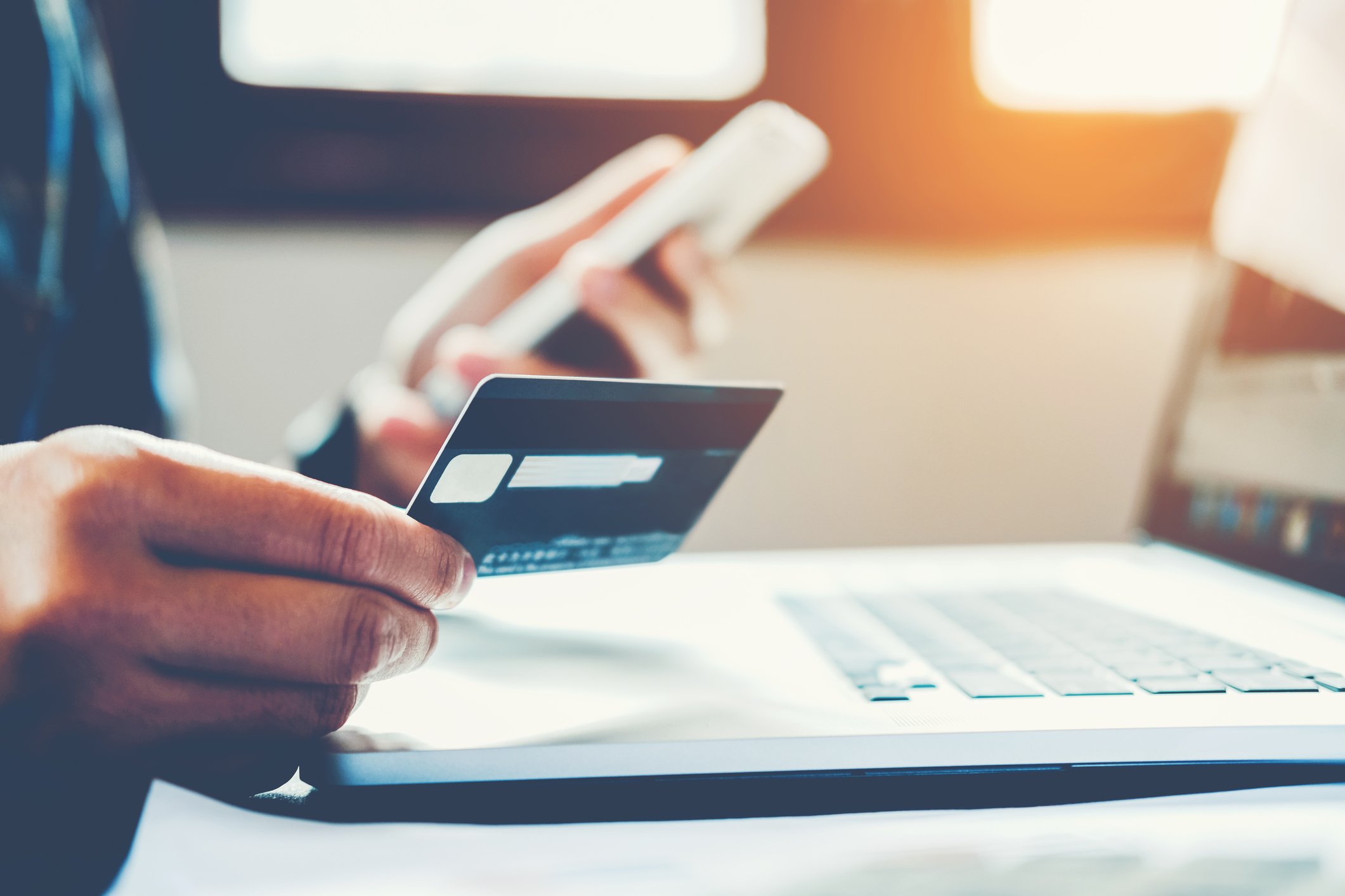 A person holding their credit card.