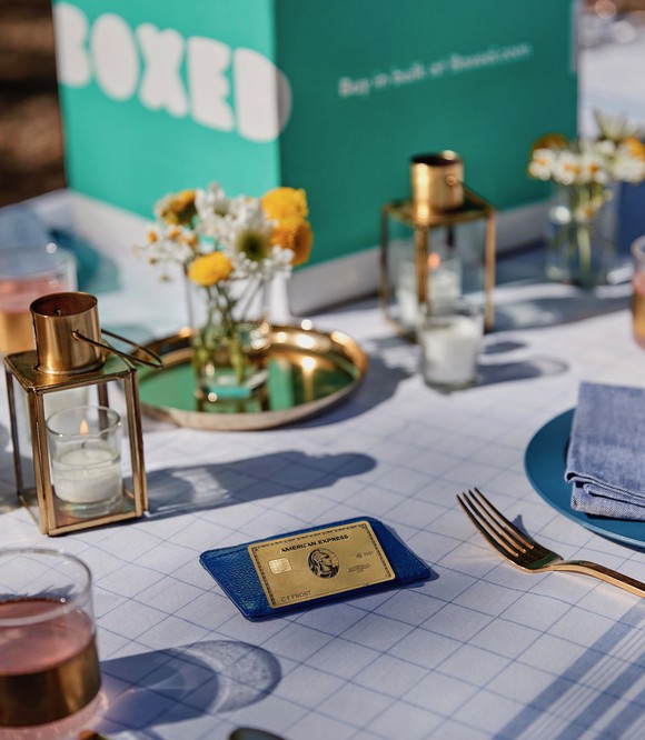 American Express gold card on a table with a Boxed delivery.