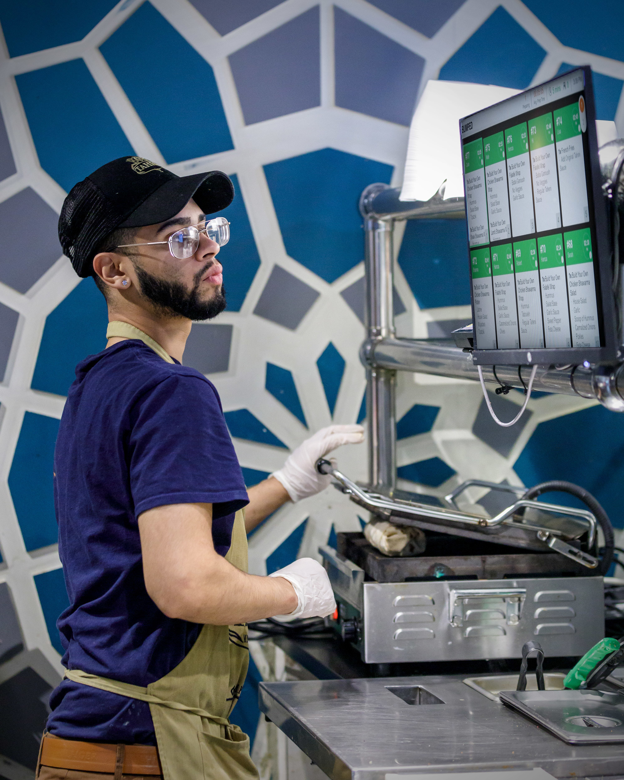 A kitchen worker checks orders on Grubhub's Ultimate platform.