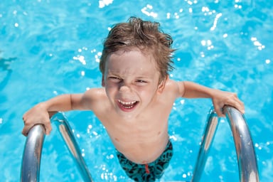boy exiting swimming pool