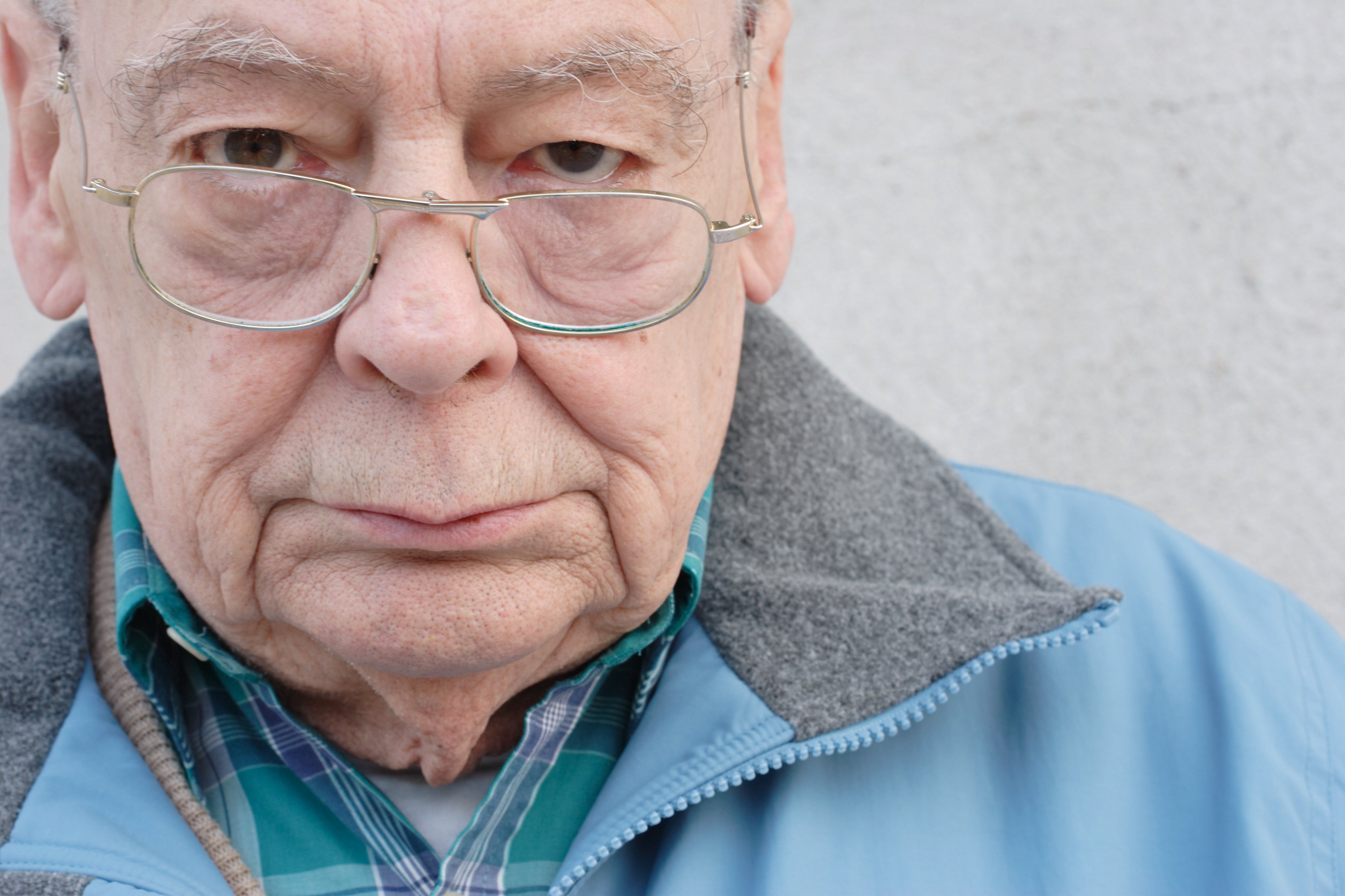 A close-up photo of an older man's face, and he looks annoyed. 