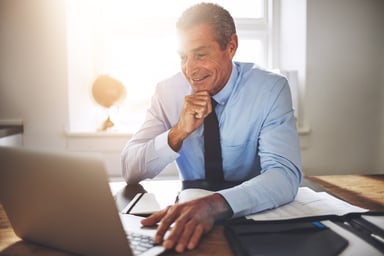 Smiling older man at laptop_GettyImages-930495990