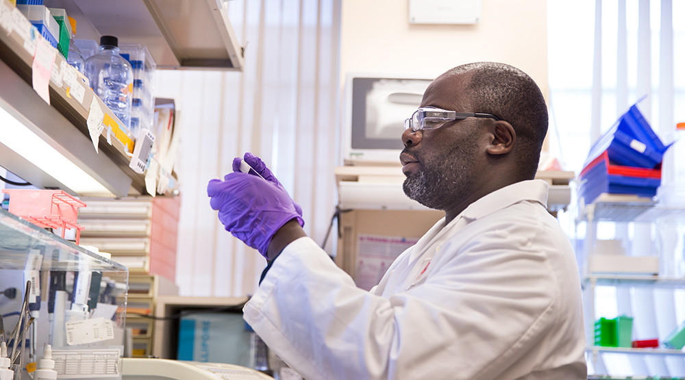 Eli Lilly lab worker with purple gloves on