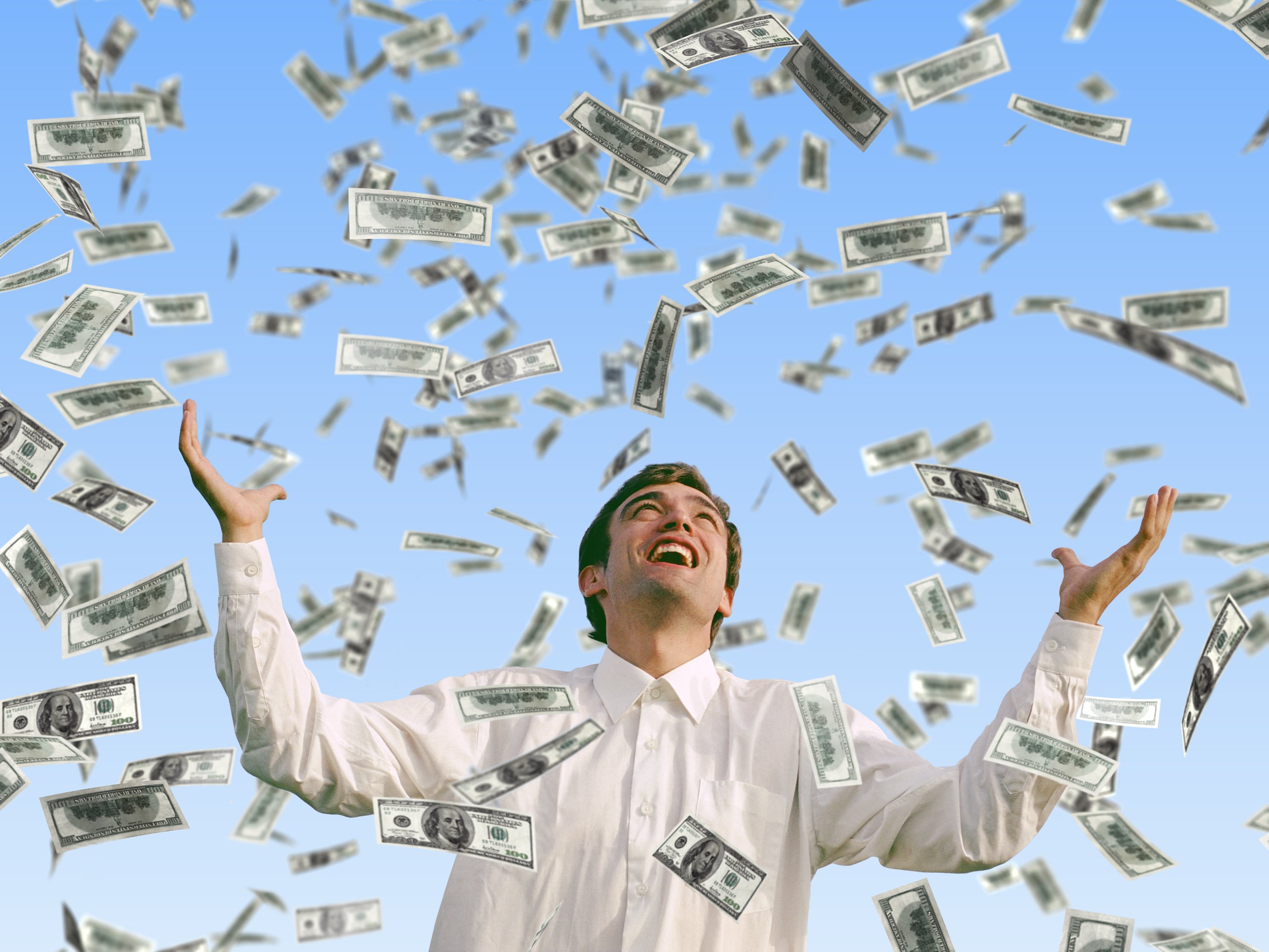 Man smiling as money rains down