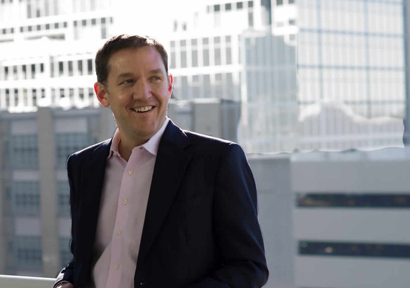 Red Hat CEO Jim Whitehurst smiles at the camera in a press image from 2015.