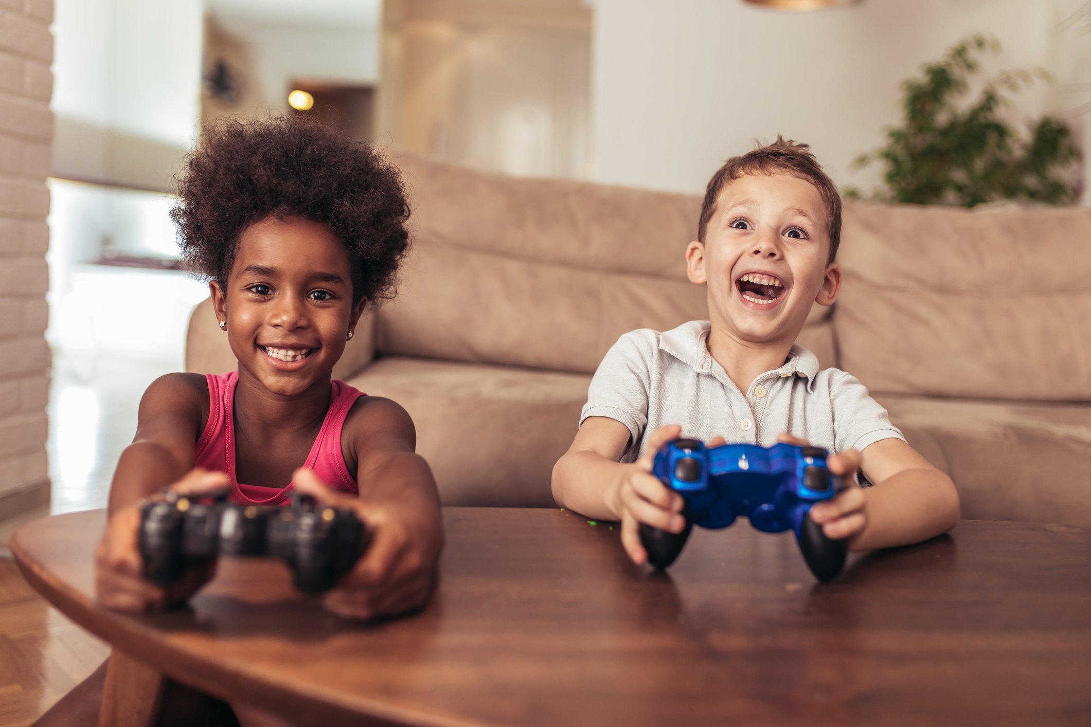 Two kids playing console games.