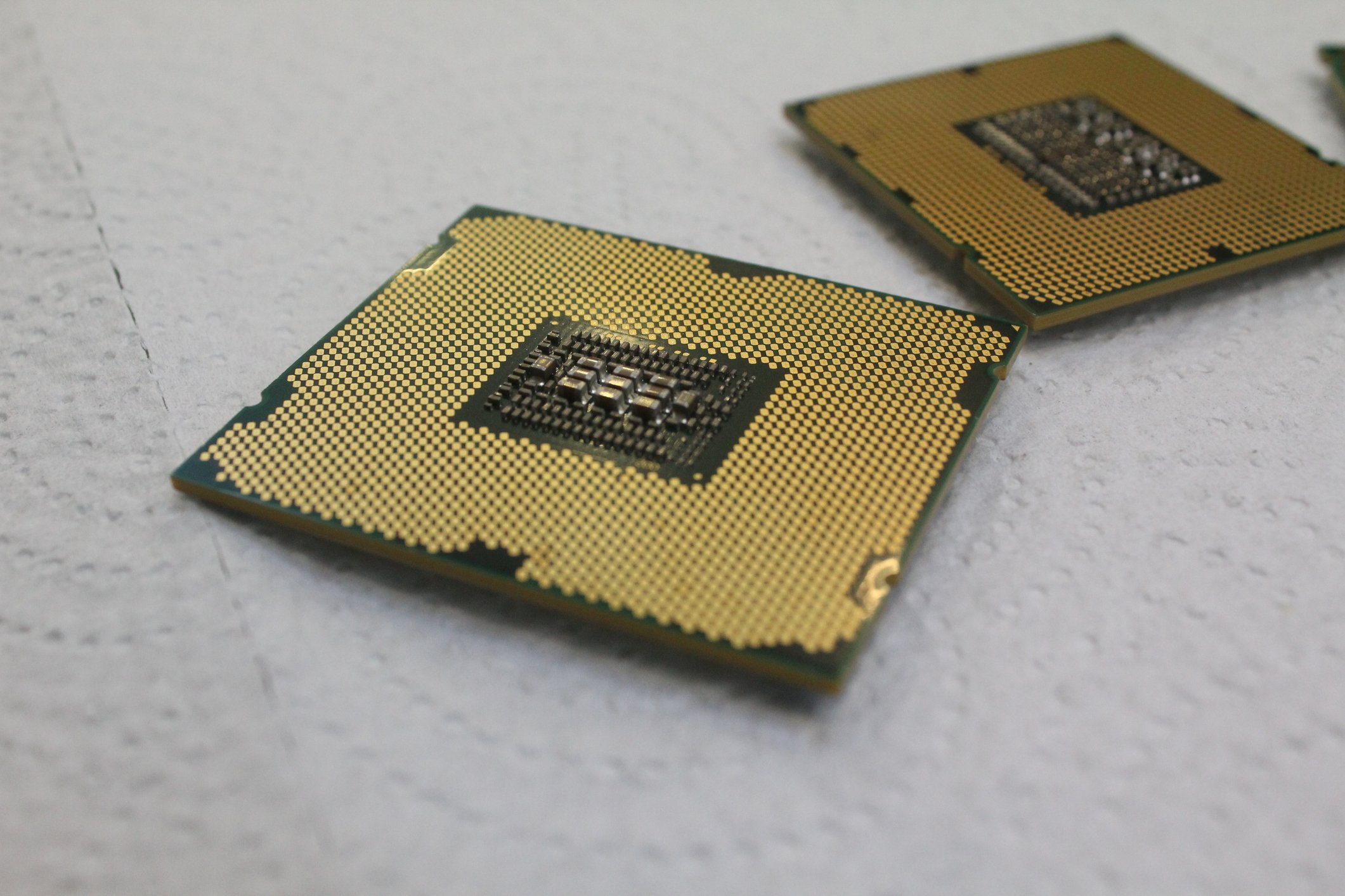 Gold-colored CPU with a similar chip to the back right. 