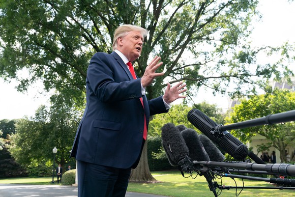 President Trump speaking to reporters on the White House lawn.