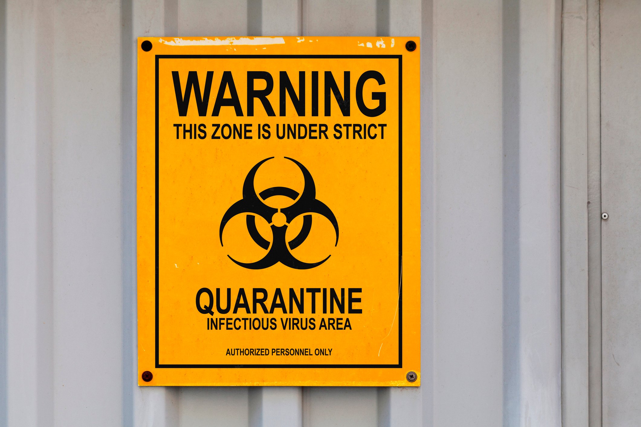A picture of a quarantine sign on a wall.